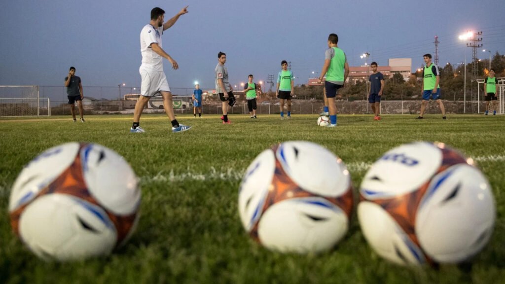 Israeli players from the Ironi Ariel football club attend a training session at their stadium in the illegal Israeli settlement of Ariel in the occupied West Bank on 21 September 2016 (Jack Guez/AFP)